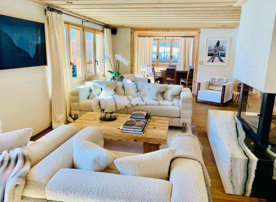 Experience luxury living in this stunning property, featuring a cozy living room with a fireplace and comfortable seating.