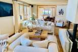 Experience luxury living in this stunning property, featuring a cozy living room with a fireplace and comfortable seating.
