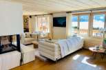 Experience luxury living in this stunning property, featuring a cozy fireplace and elegant wooden floors.