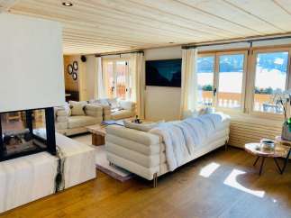 Experience luxury living in this stunning property, featuring a cozy fireplace and elegant wooden floors.