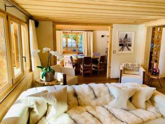 Experience luxury living in this stunning property, featuring a cozy living room with a plush sofa and elegant decor.