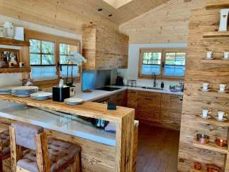 This stunning kitchen boasts a rustic yet modern design, perfect for a cozy and inviting atmosphere.