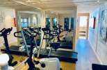 This luxurious gym boasts a modern design with state-of-the-art equipment, perfect for a comprehensive workout.