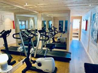 This luxurious gym boasts a modern design with state-of-the-art equipment, perfect for a comprehensive workout.