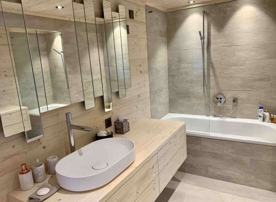 This stunning bathroom boasts a modern design with a touch of rustic charm.
