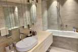 This stunning bathroom boasts a modern design with a touch of rustic charm.
