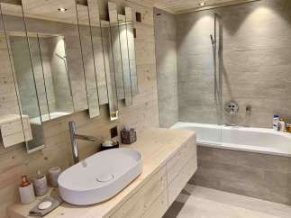 This stunning bathroom boasts a modern design with a touch of rustic charm.