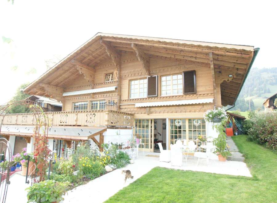 This stunning wooden chalet boasts intricate architectural details and a warm, inviting ambiance.