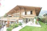 This stunning wooden chalet boasts intricate architectural details and a warm, inviting ambiance.