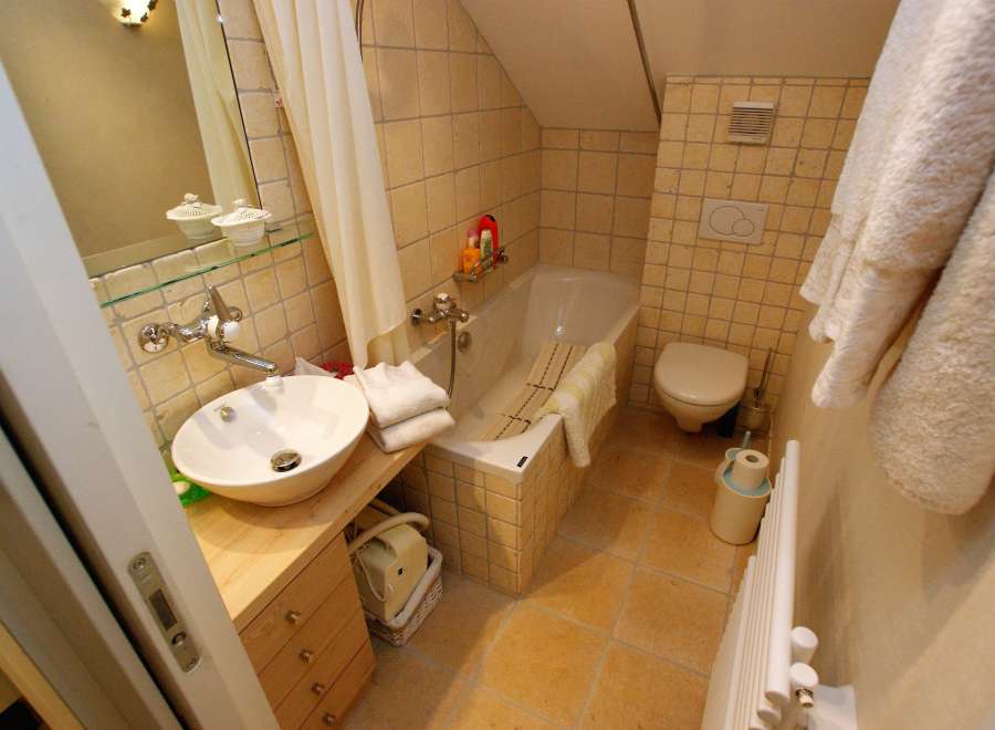This cozy bathroom features a stylish sink and vanity, perfect for daily routines.
