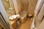 This cozy bathroom features a stylish sink and vanity, perfect for daily routines.