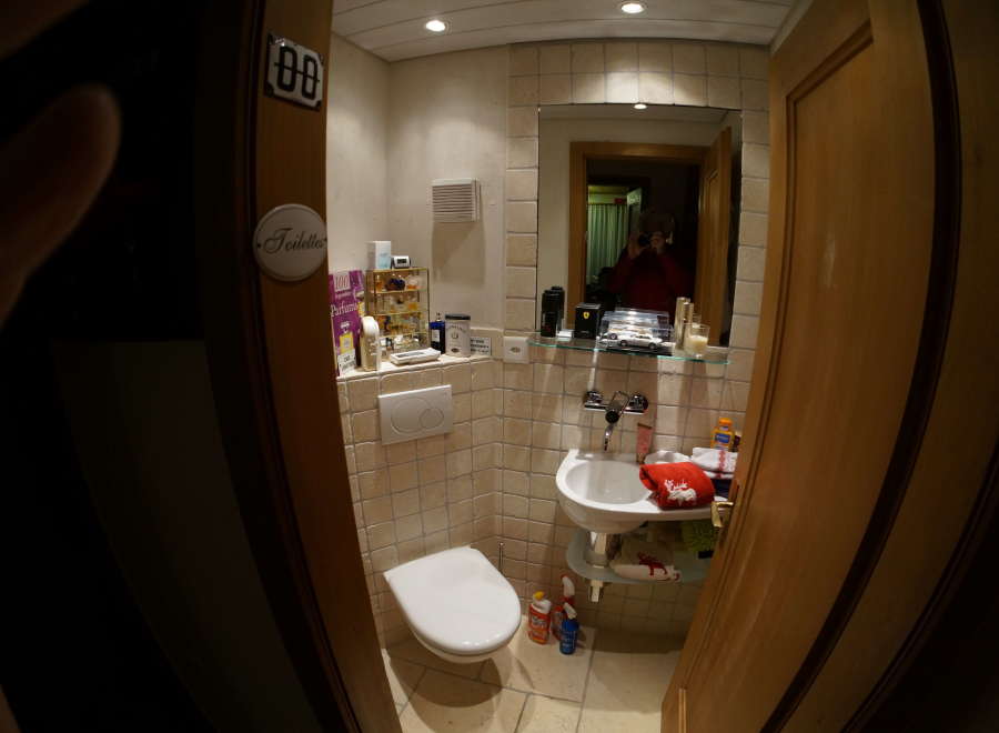 This cozy bathroom features a clean white toilet and sink, perfect for a comfortable stay.