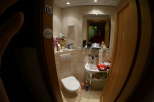 This cozy bathroom features a clean white toilet and sink, perfect for a comfortable stay.