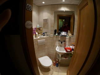 This cozy bathroom features a clean white toilet and sink, perfect for a comfortable stay.