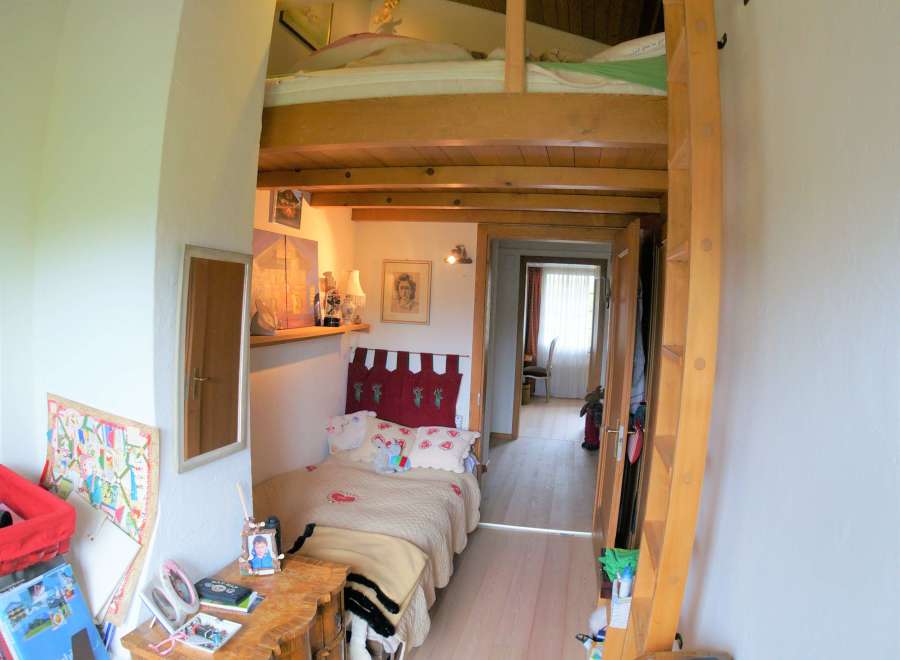 Cozy and unique bedroom with a loft bed, perfect for maximizing space.
