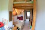 Cozy and unique bedroom with a loft bed, perfect for maximizing space.