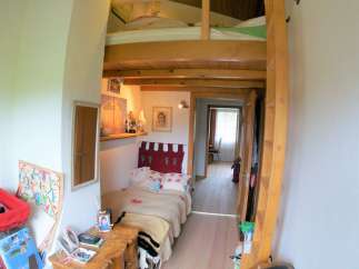 Cozy and unique bedroom with a loft bed, perfect for maximizing space.