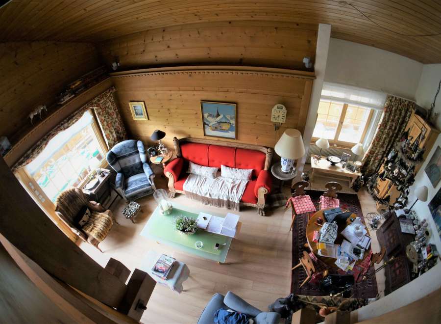 This cozy living space features a charming wooden ceiling and walls, creating a warm and inviting atmosphere.