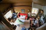 This cozy living space features a charming wooden ceiling and walls, creating a warm and inviting atmosphere.