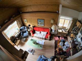 This cozy living space features a charming wooden ceiling and walls, creating a warm and inviting atmosphere.