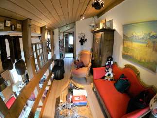 Step into a charming, rustic interior with exposed wooden beams and a cozy atmosphere.