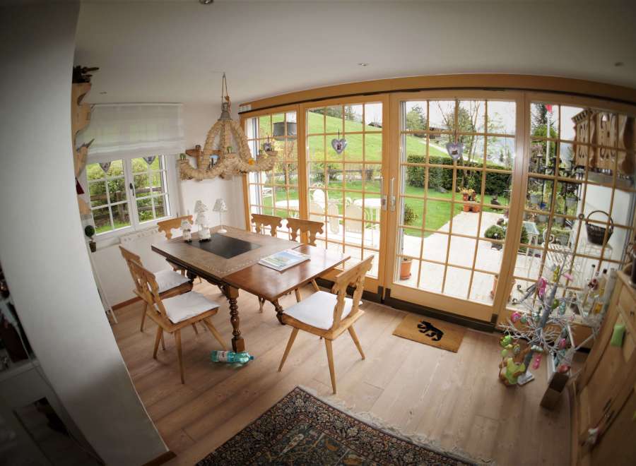 This charming dining room features a rustic wooden table and chairs, perfect for family gatherings.