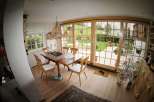 This charming dining room features a rustic wooden table and chairs, perfect for family gatherings.