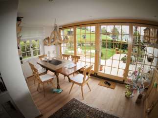 This charming dining room features a rustic wooden table and chairs, perfect for family gatherings.