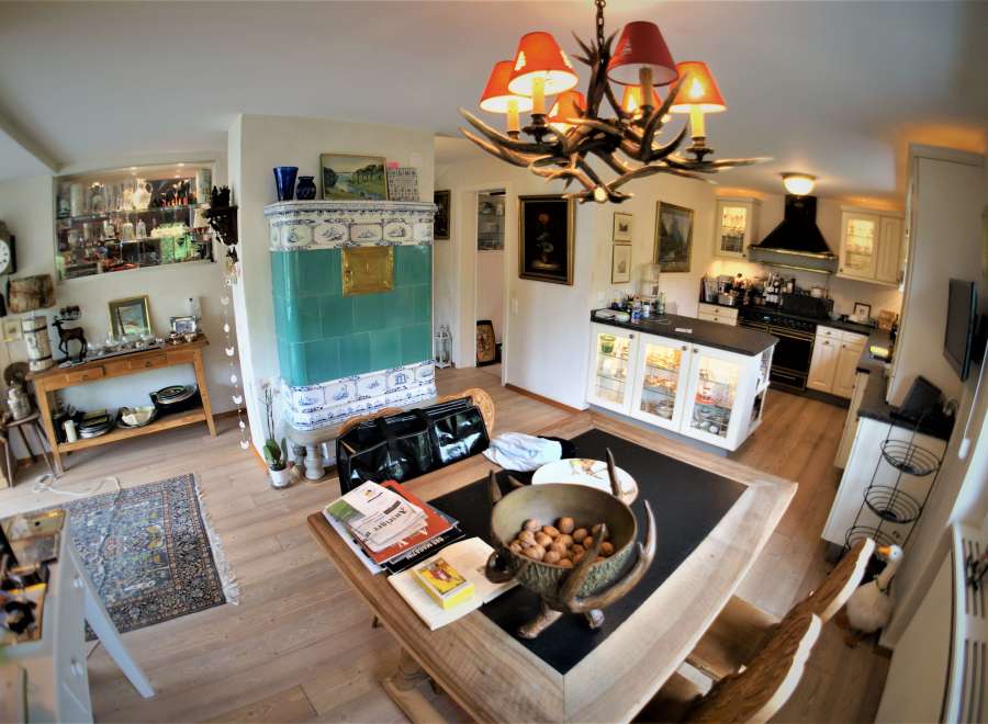 This charming kitchen boasts a unique antler chandelier, adding a touch of rustic elegance.