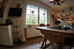 This charming dining room features a rustic wooden table, perfect for family gatherings.