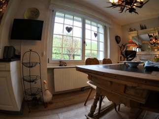 This charming dining room features a rustic wooden table, perfect for family gatherings.
