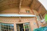 Discover the charm of this stunning wooden chalet, showcasing intricate carvings and a warm, inviting ambiance.