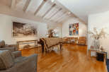 Elegant living space featuring a grand piano and hardwood floors.