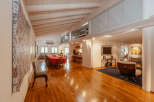 This stunning property boasts a spacious, open-plan living area with a beautiful wooden floor.