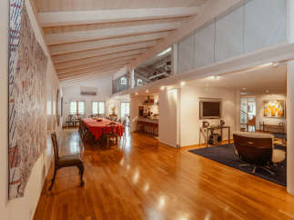 This stunning property boasts a spacious, open-plan living area with a beautiful wooden floor.