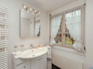 This charming bathroom features a bright and airy design, perfect for a relaxing retreat.
