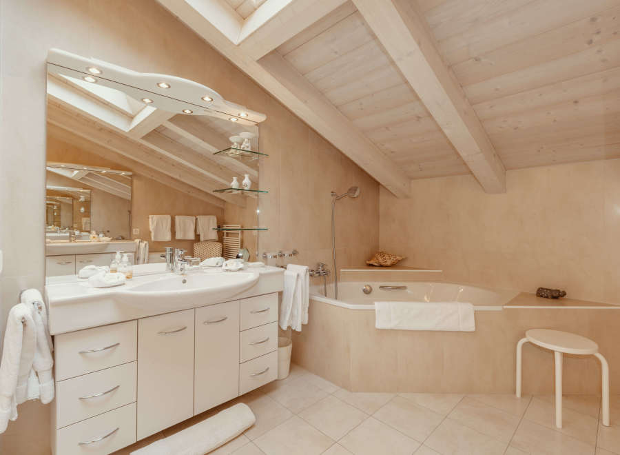 This luxurious bathroom features a modern design with a spacious vanity and a relaxing bathtub.