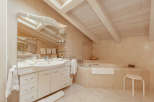 This luxurious bathroom features a modern design with a spacious vanity and a relaxing bathtub.