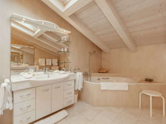 This luxurious bathroom features a modern design with a spacious vanity and a relaxing bathtub.