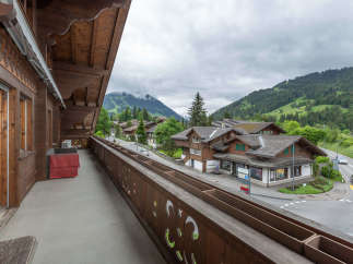 Enjoy breathtaking mountain views from this charming balcony.