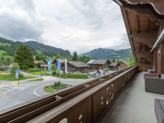 Enjoy breathtaking mountain views from this charming balcony.