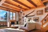 Experience the charm of this cozy chalet, featuring a warm wooden interior and stunning mountain views.