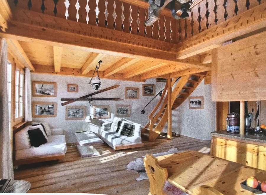 Experience the charm of this rustic chalet, featuring a cozy living area with a loft and wooden beams.