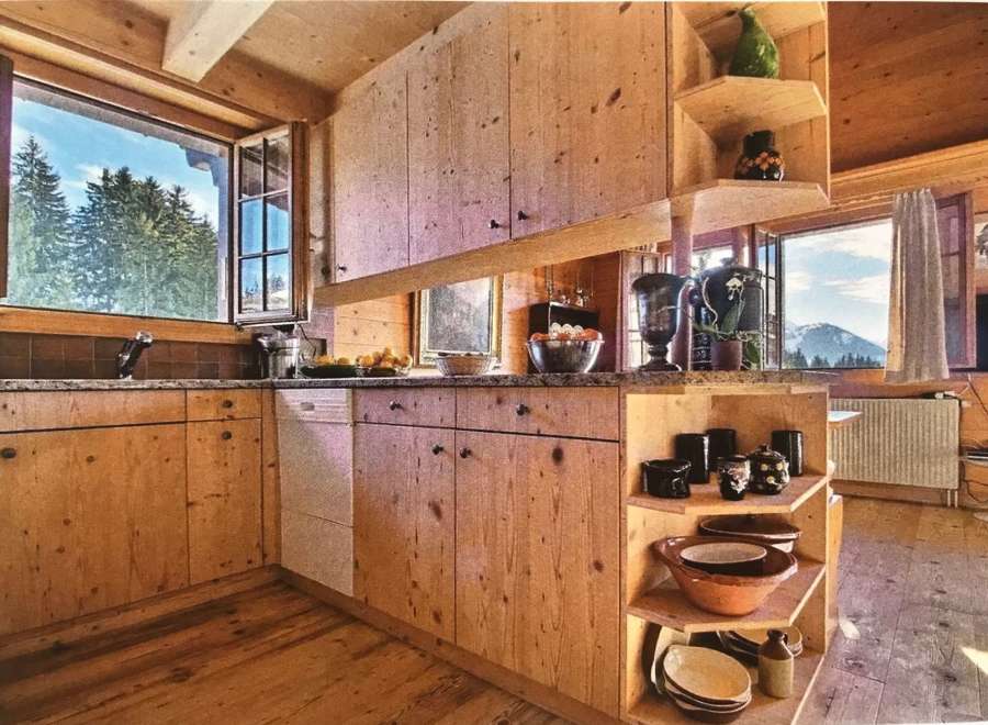 This charming kitchen boasts a rustic, wooden design, creating a warm and inviting atmosphere.