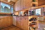 This charming kitchen boasts a rustic, wooden design, creating a warm and inviting atmosphere.