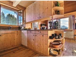 This charming kitchen boasts a rustic, wooden design, creating a warm and inviting atmosphere.