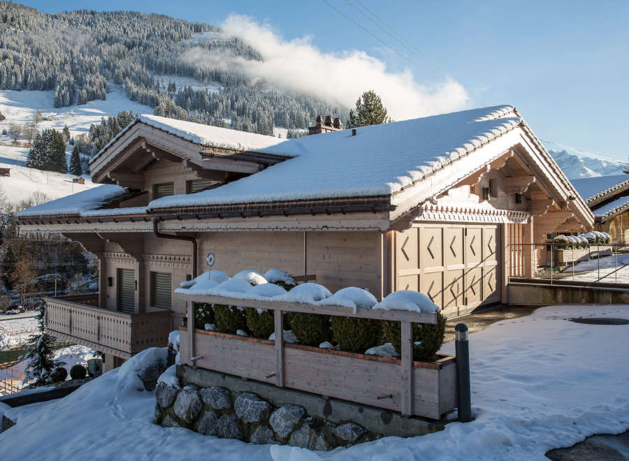 This stunning chalet boasts a picturesque winter landscape, perfect for a cozy getaway.