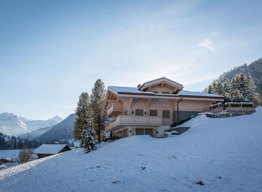 Experience the ultimate winter escape in this stunning chalet nestled in a snowy landscape.