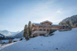 Experience the ultimate winter escape in this stunning chalet nestled in a snowy landscape.