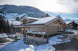 Discover the charm of this stunning chalet nestled in a snowy mountain landscape.
